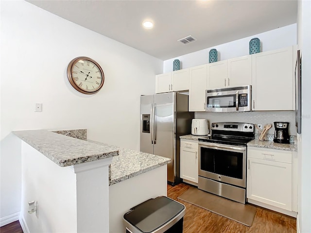 kitchen with white cabinets and appliances with stainless steel finishes