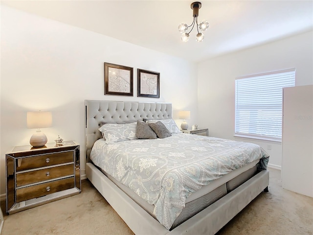 carpeted bedroom with a chandelier