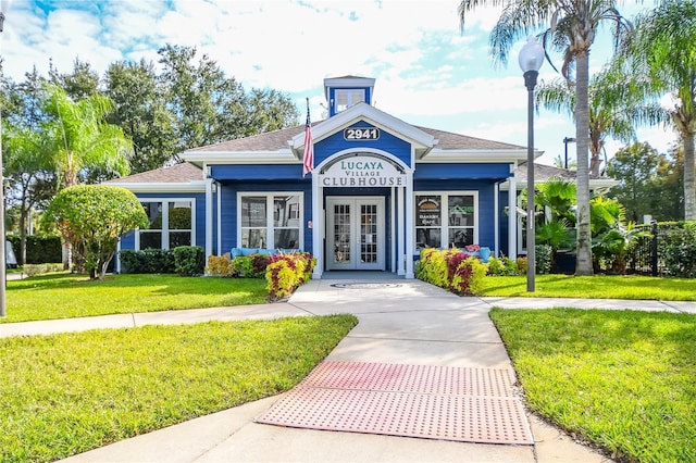 view of front of home featuring a front yard and french doors