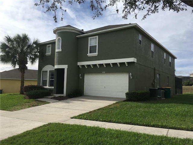 view of front of home with a front yard and a garage