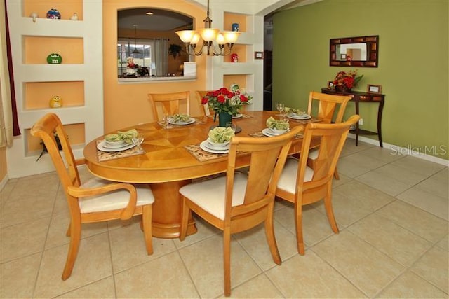 tiled dining area with a notable chandelier