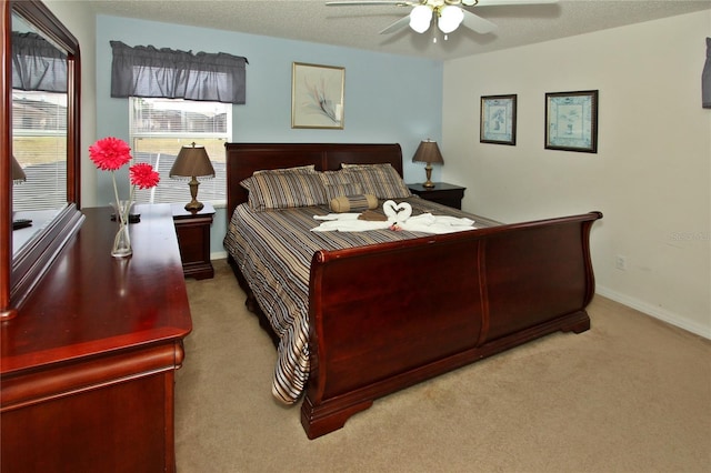 carpeted bedroom with a textured ceiling and ceiling fan