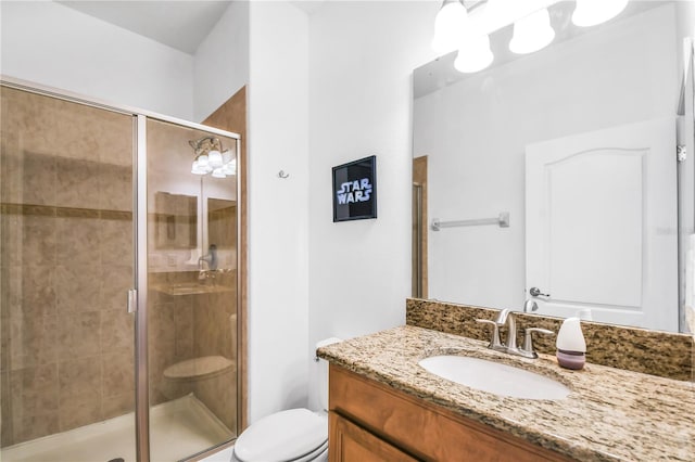 bathroom with walk in shower, toilet, and vanity