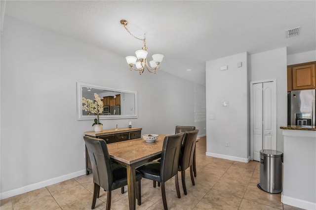 tiled dining area with an inviting chandelier