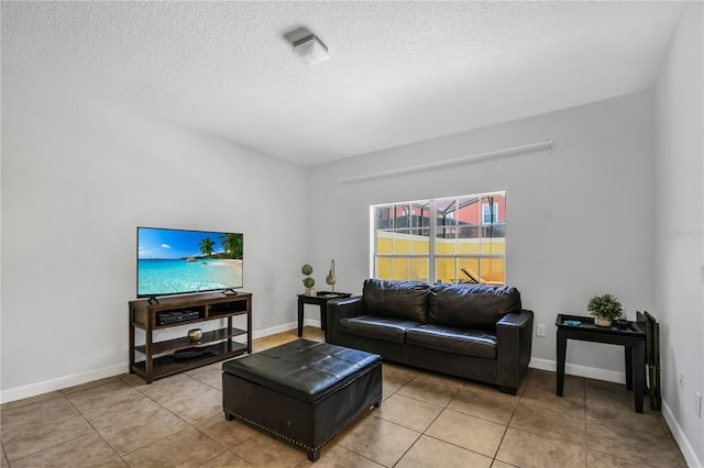 living room with a textured ceiling and light tile floors