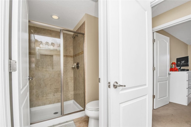 bathroom featuring an enclosed shower and toilet