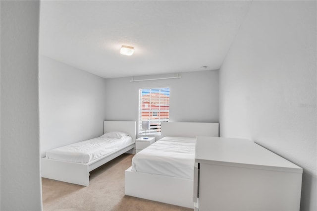 bedroom featuring light carpet