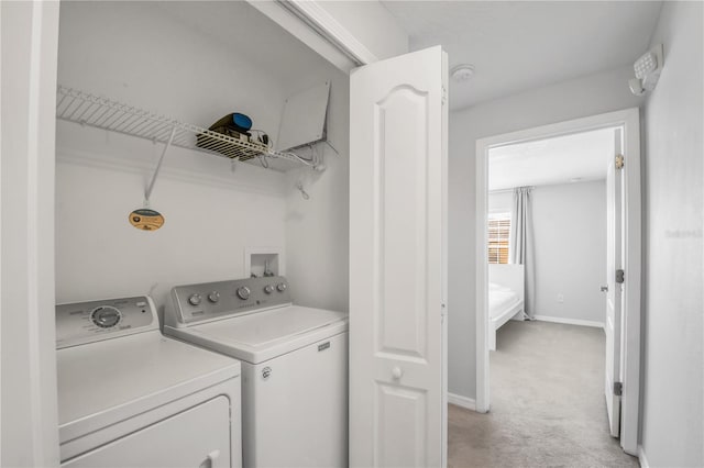 laundry room featuring hookup for a washing machine, washer and dryer, and light carpet