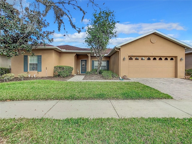 ranch-style house featuring a front lawn and a garage