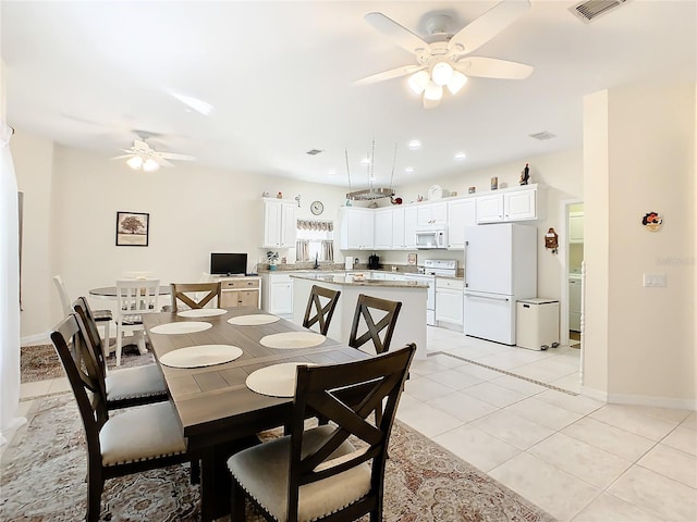 dining area with washer / clothes dryer, light tile flooring, and ceiling fan