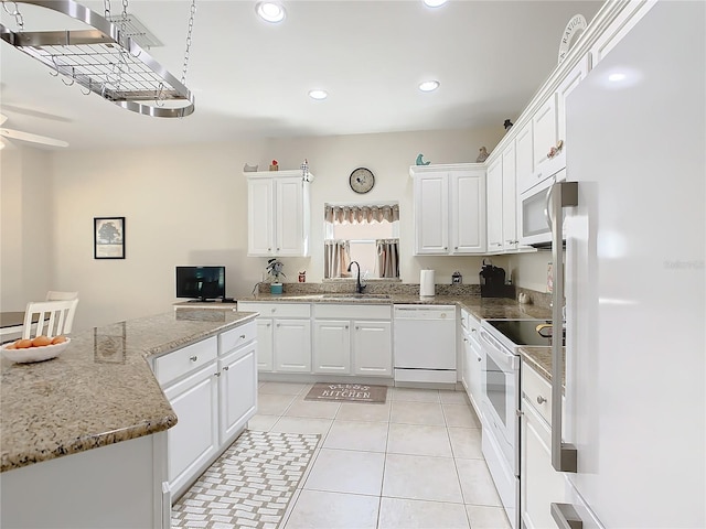 kitchen with white appliances, ceiling fan, white cabinetry, and light tile floors