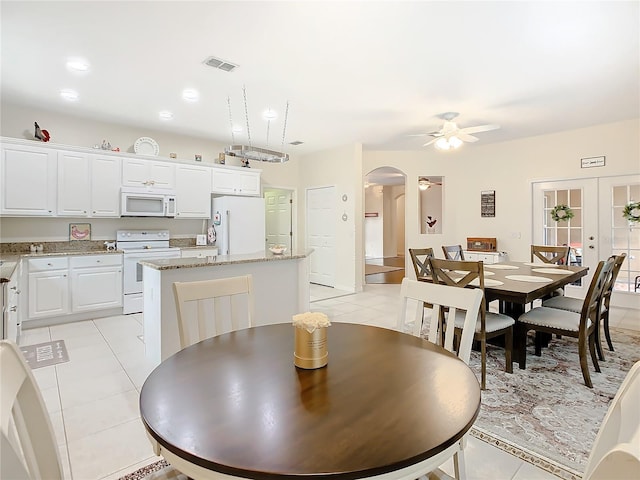 tiled dining area featuring french doors and ceiling fan