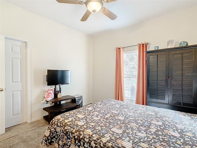 bedroom with light colored carpet and ceiling fan