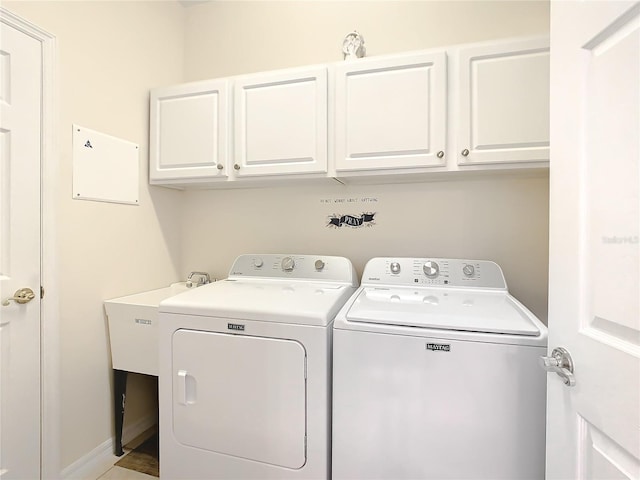 clothes washing area featuring cabinets, separate washer and dryer, and sink