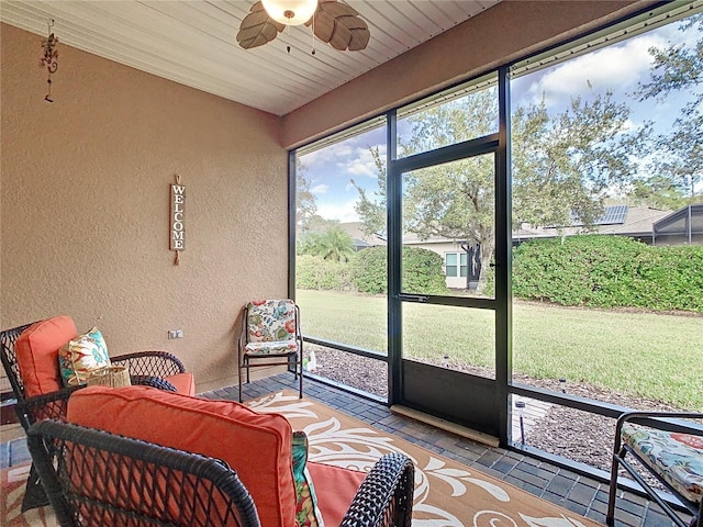 sunroom / solarium featuring ceiling fan