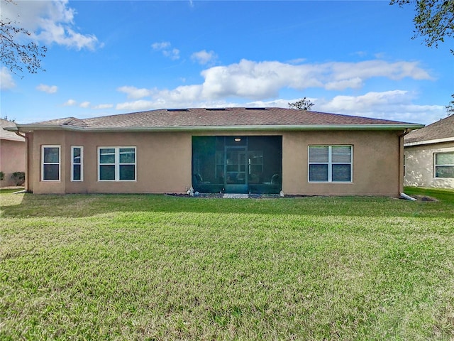 rear view of property with a yard