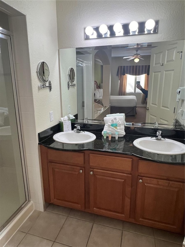 bathroom featuring tile flooring, large vanity, double sink, and ceiling fan