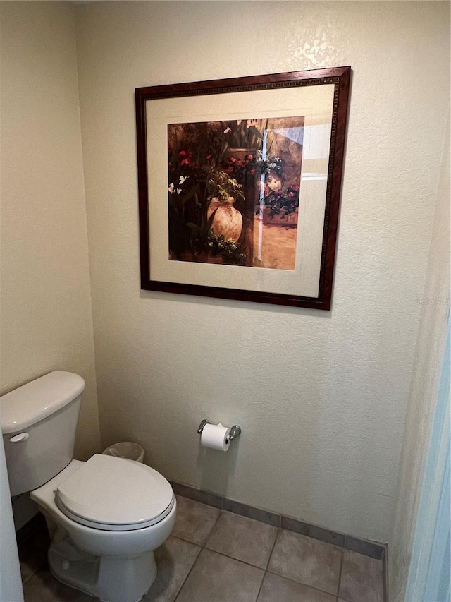 bathroom with toilet and tile flooring