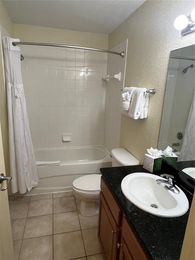 full bathroom featuring toilet, shower / tub combo, tile floors, a textured ceiling, and large vanity