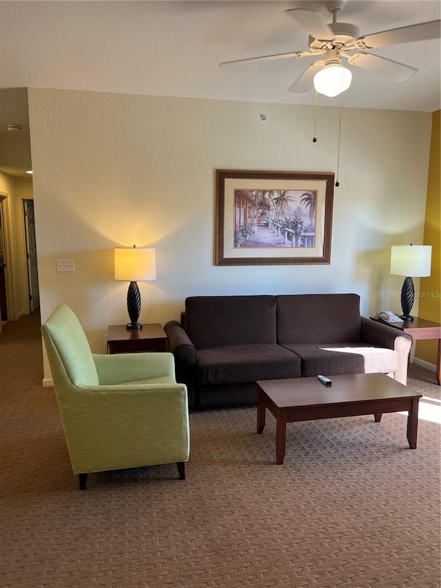 carpeted living room with ceiling fan