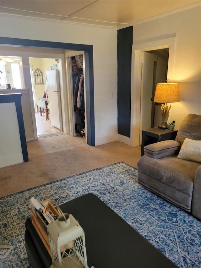 carpeted living room featuring crown molding