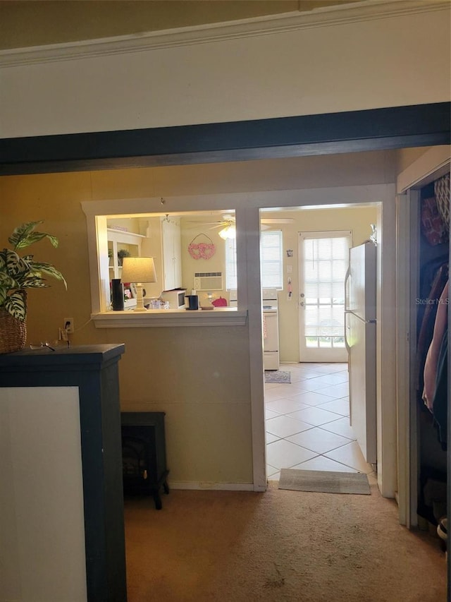 corridor featuring light colored carpet and crown molding