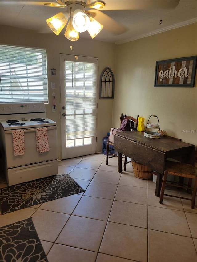 interior space with light tile flooring, ornamental molding, ceiling fan, and white electric stove