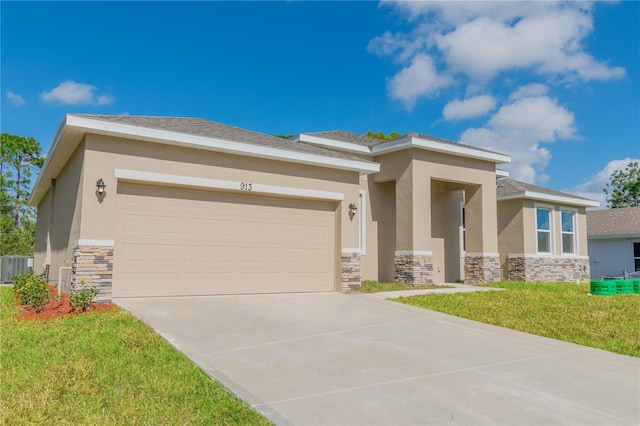 prairie-style home with central AC unit, a front yard, and a garage