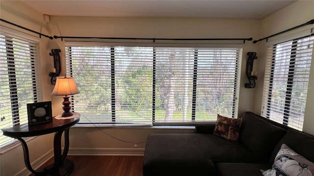 living room with plenty of natural light and dark wood-type flooring