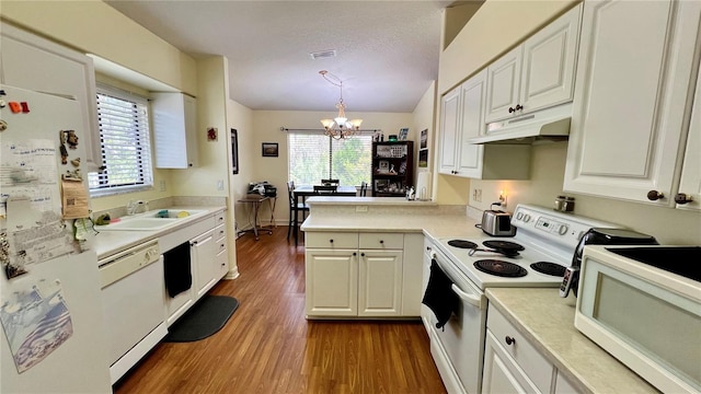 kitchen featuring a chandelier, decorative light fixtures, white appliances, white cabinetry, and dark hardwood / wood-style flooring