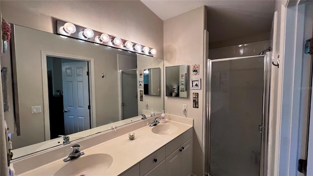 bathroom with double sink, an enclosed shower, and oversized vanity