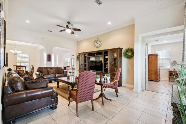 living room with light tile floors, crown molding, and ceiling fan with notable chandelier