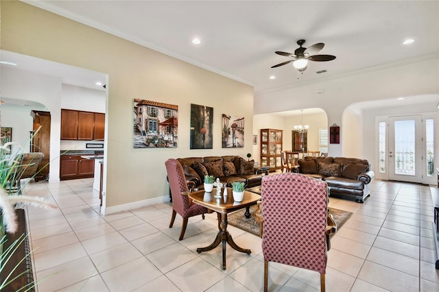 tiled living room featuring crown molding and ceiling fan with notable chandelier