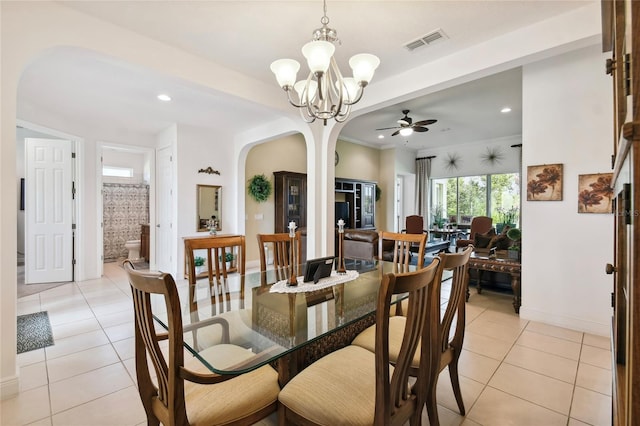 dining room featuring ceiling fan with notable chandelier and light tile floors