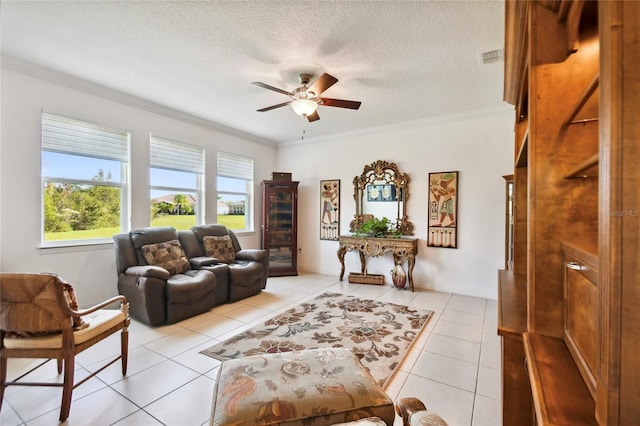 living room featuring ornamental molding, a textured ceiling, ceiling fan, and light tile floors