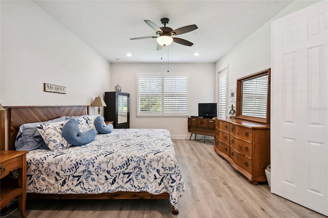 bedroom with ceiling fan and light hardwood / wood-style flooring