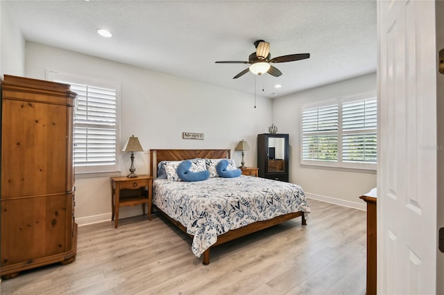 bedroom with light hardwood / wood-style floors and ceiling fan