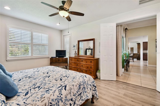 bedroom with ceiling fan and light hardwood / wood-style flooring