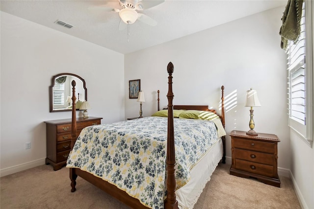 bedroom featuring light carpet and ceiling fan