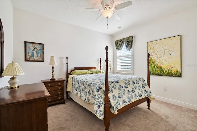 bedroom with light carpet, a textured ceiling, and ceiling fan