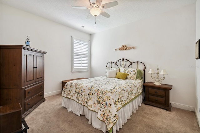 bedroom featuring light carpet and ceiling fan