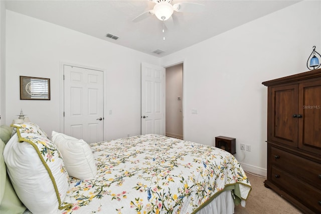 carpeted bedroom featuring a closet and ceiling fan