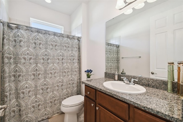 bathroom featuring toilet and vanity