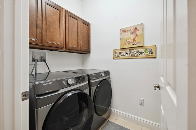 washroom with light tile flooring, separate washer and dryer, hookup for a washing machine, and cabinets