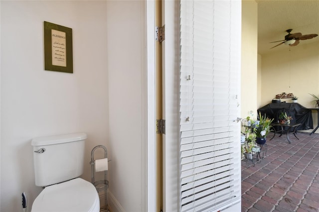 bathroom featuring toilet and ceiling fan