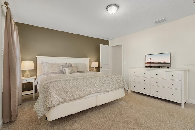 bedroom featuring light carpet