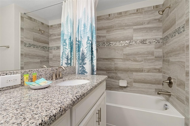 bathroom with shower / tub combo with curtain, vanity, and a textured ceiling