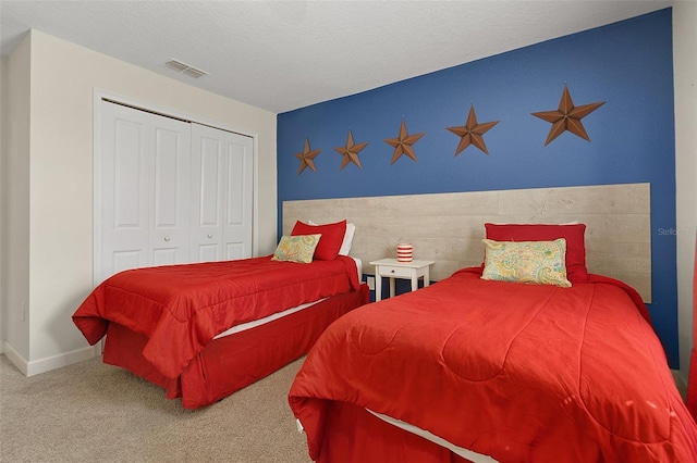 bedroom featuring a textured ceiling, a closet, and carpet