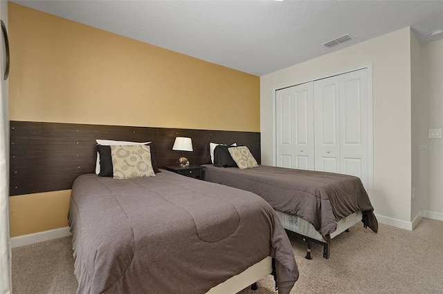 bedroom featuring a closet and light carpet