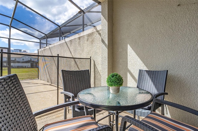 view of patio featuring glass enclosure